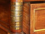 a close up of a wooden cabinet with a marble top