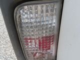 a close up of a car ' s tail light with a red sticker on it