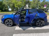 a blue suv with its door open on the street