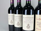 six bottles of red wine lined up in a row on a table