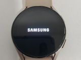 the samsung watch is sitting on top of a white surface