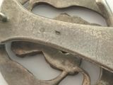 a close up of a metal object on a white surface