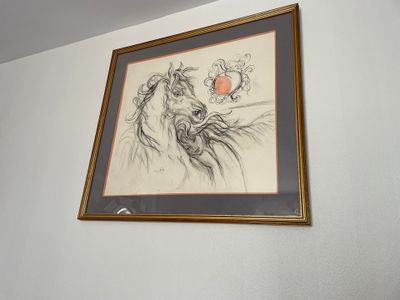 a picture of a drawing on the wall above a bed