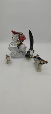 figurine of a man on a sled with birds on it