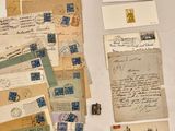 a pile of old letters and envelopes sitting on a table