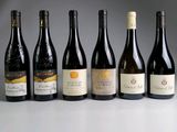 several bottles of wine are lined up on a table