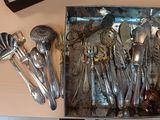 a box with a bunch of silver spoons and spoons in it