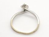 an engagement ring with a single stone in the middle of it