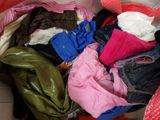 a box full of clothes that is sitting on the floor