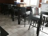 tables and chairs in a restaurant with boxes and boxes on the floor