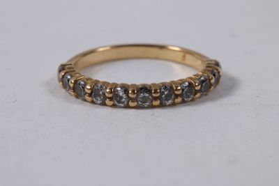 a close up of a gold ring with grey diamonds on it