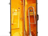 a trumpet in a case that is open on a white background