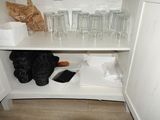 a white cupboard with glasses and other items on it