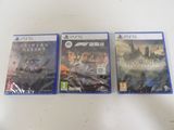 three video games are sitting on a table with a white table cloth
