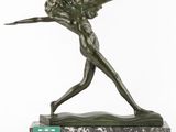 a bronze statue of a woman holding a sword on a marble base