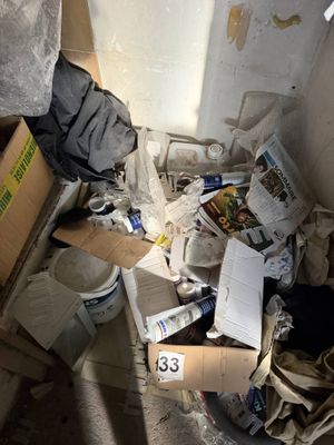 a pile of papers and other items in a room
