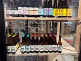 many bottles of beer on display in a refrigerator