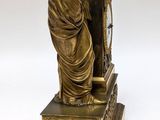 a statue of a woman sitting on top of a book