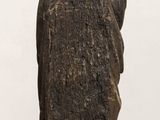 statue of a woman holding a child in her arms on a wooden table