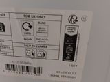 the label on the back of a white refrigerator is clearly visible