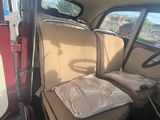 an image of a seat in a car with a pillow on it