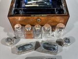 a wooden box that has a set of glass items in it