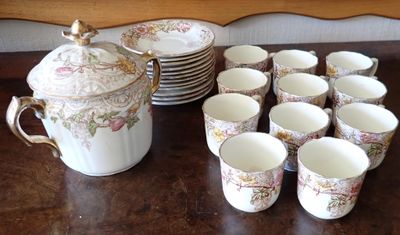 many cups and a teapot sitting on a table