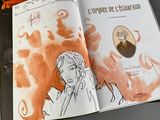 an open book with a drawing of a woman on it