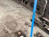 a pile of tires sitting on the floor next to a blue pole
