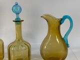 three glass vases sitting next to each other on a table