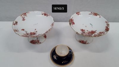pair of porcelain bowls and saucers with red flowers on them