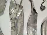 many different types of knives and spoons on the table