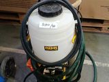 a large white tank with a hose attached to it in a warehouse