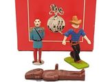 two figurines of a man and a woman in front of a red box