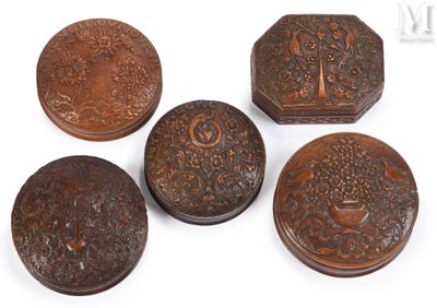 four small wooden boxes with carvings on them sitting on a white surface