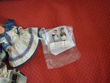 a doll that is laying on the floor next to a bag