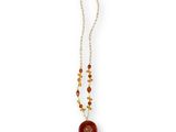 a necklace with a red bead and a gold chain