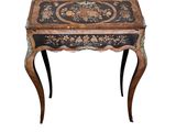 an image of a small wooden table with a black and gold decoration