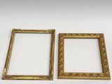 two gold picture frames on a white background