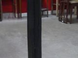 a black pedestal with a clock on it in a room