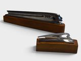 a stapler and a pair of scissors on a wooden stand