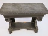 a small table with a black top on a white surface