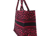 a red and black leopard print tote bag on a white background
