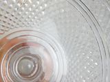 a glass plate with a glass bowl inside of it
