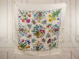 a white wall with a colorful floral design on it