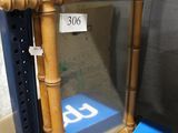 a blue sign on the shelf next to a mirror