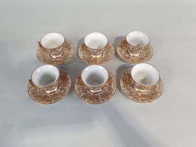 six coffee cups and saucers are sitting on a table
