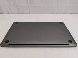 the back of a laptop computer sitting on top of a white surface