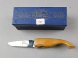 a knife that is sitting next to a box on a table