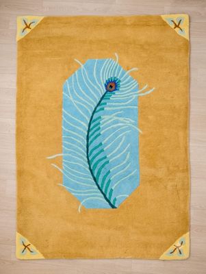 an image of a rug with a blue feather on it